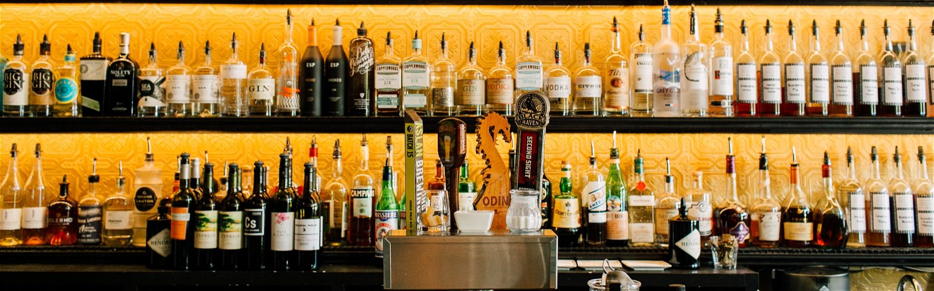 Line up of bar offerings with a golden backdrop
