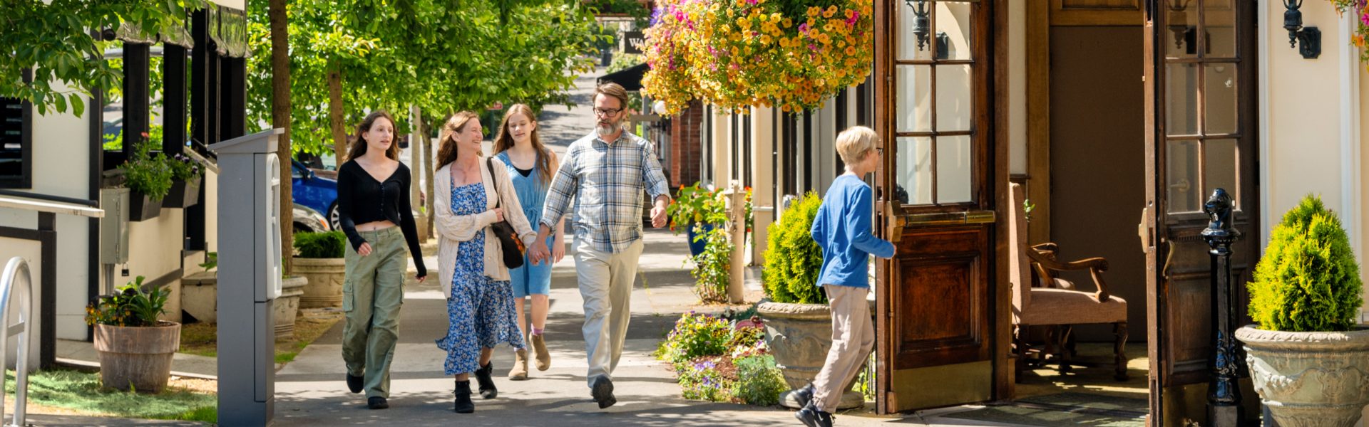 A family of five entering a hotel