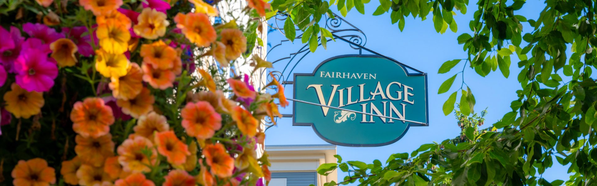 Fairhaven Village Inn among flowers and tree branches